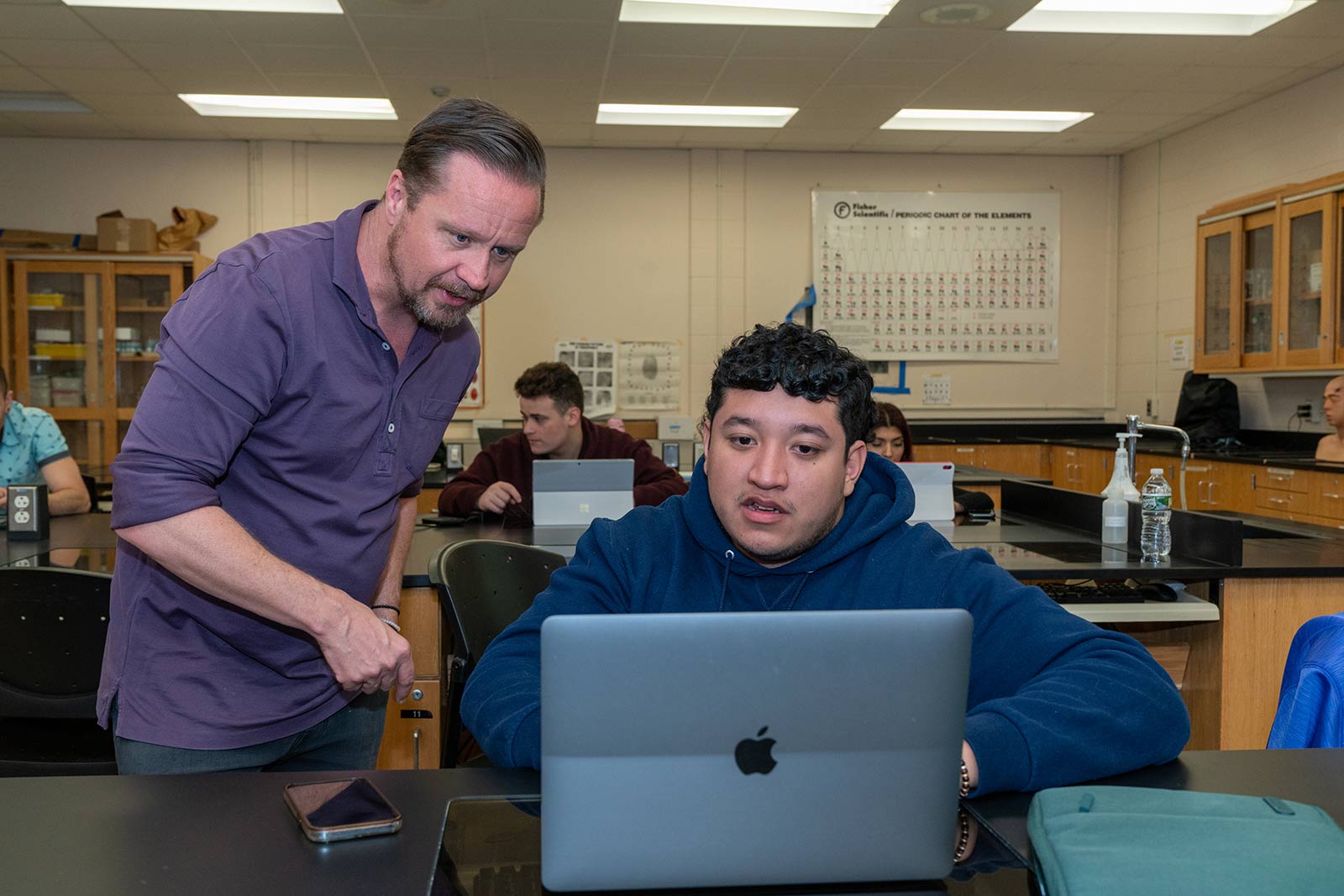 Professor with student in classroom