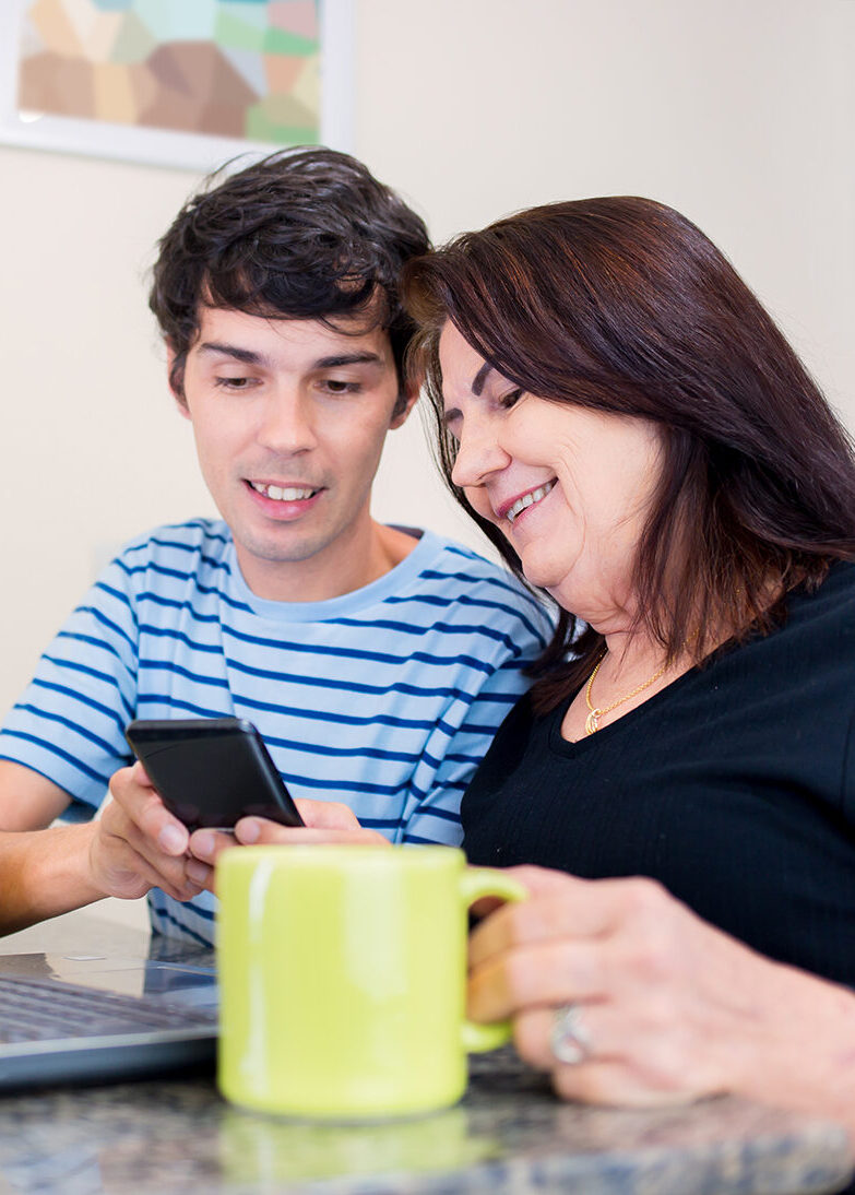 Image of mother working with student at laptop
