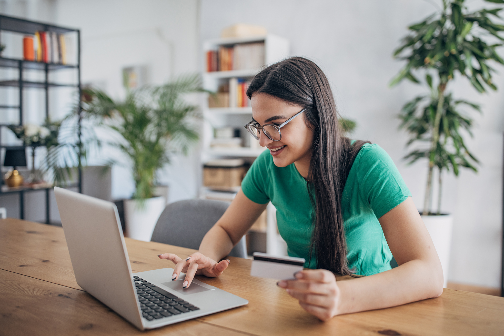 Image of a college student paying their bill with credit card on a laptop