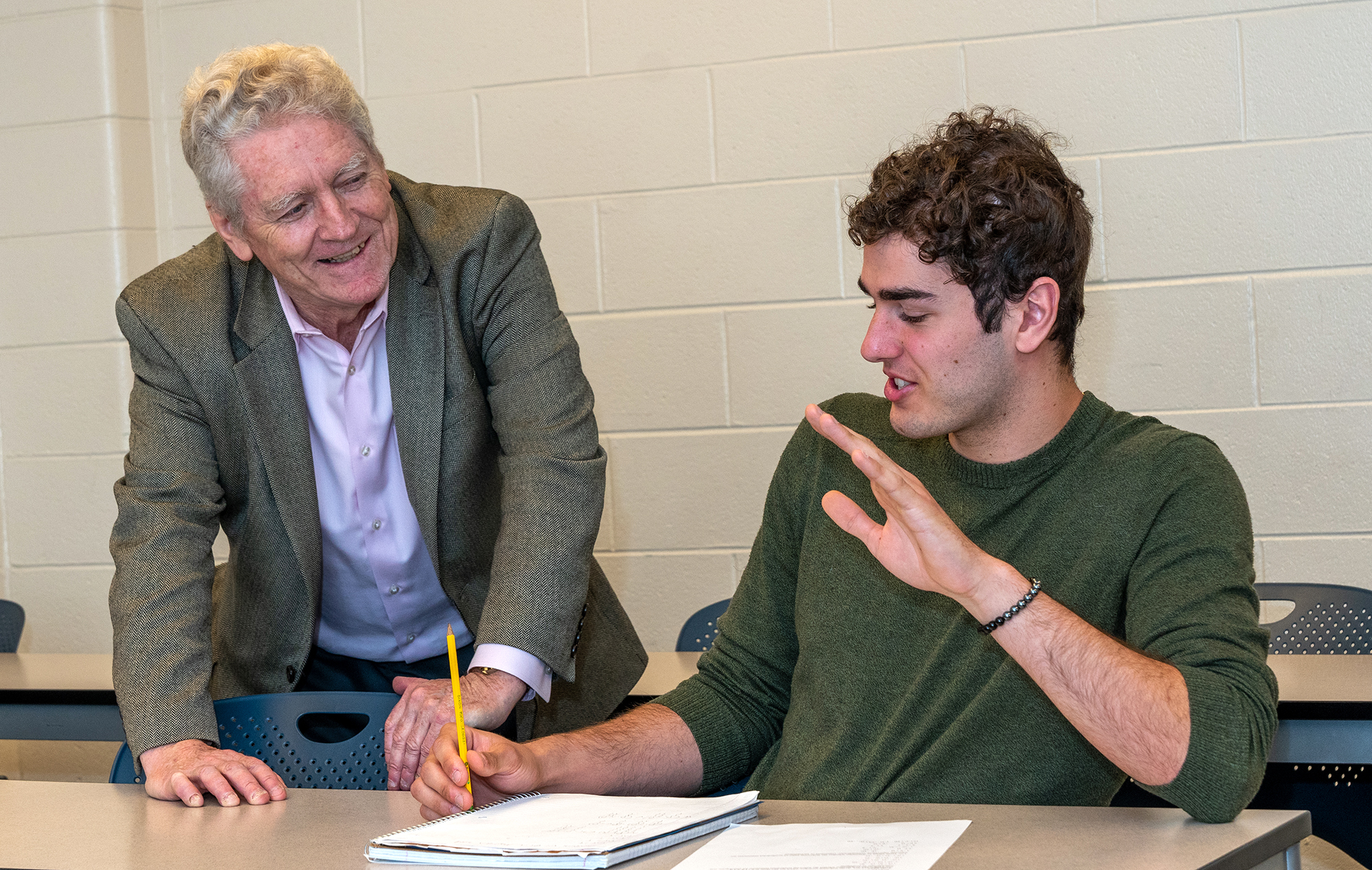 Image of faculty working with a student