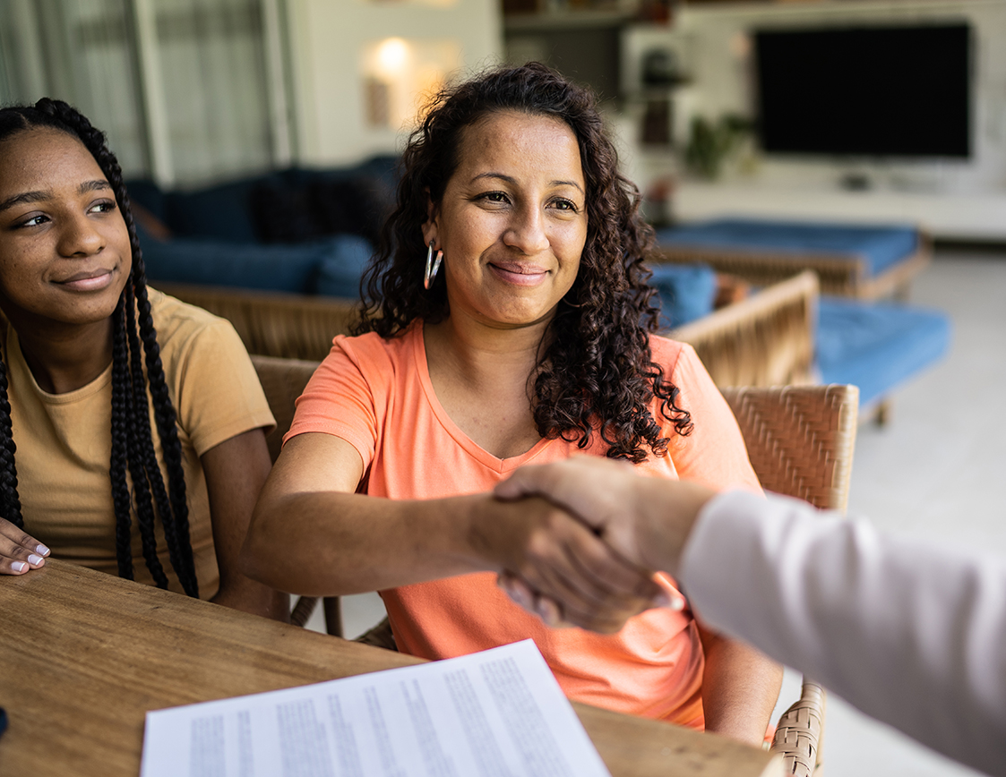 Image of Women shaking hands in CCM's Womens Center