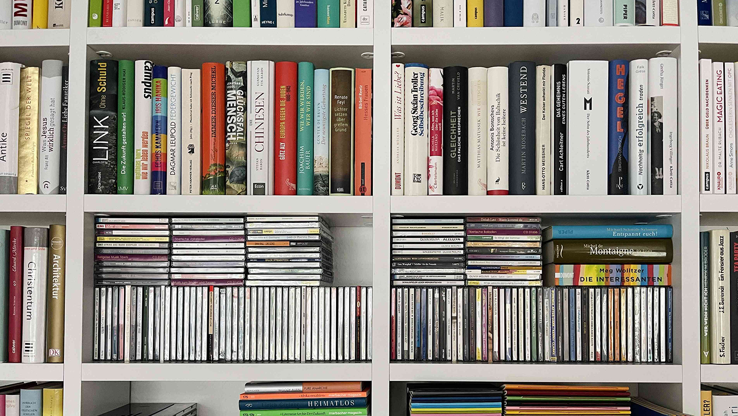 Image of a bookshelf holding books and CDs