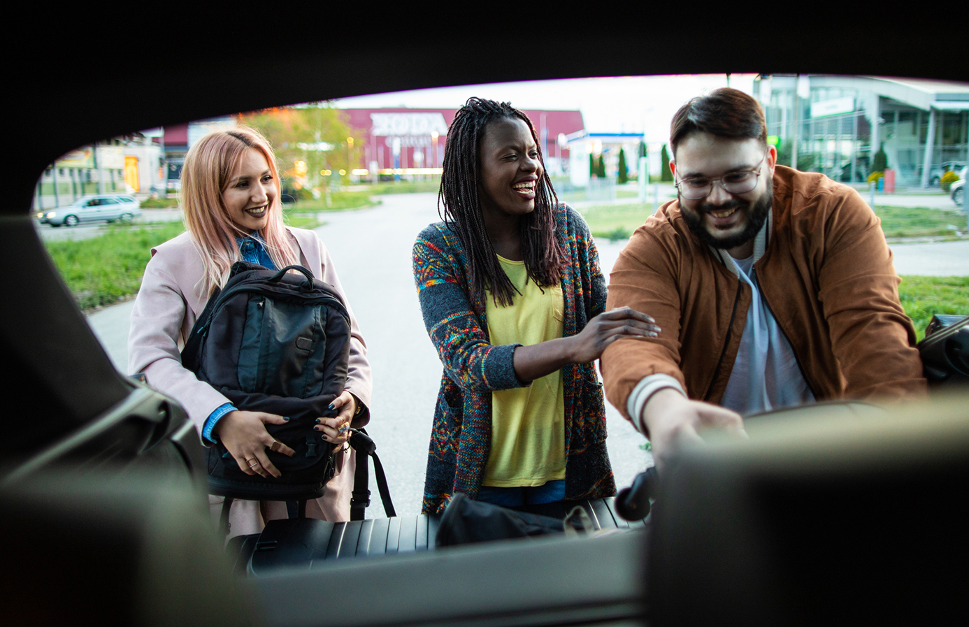 Image of students placing bags in back of car