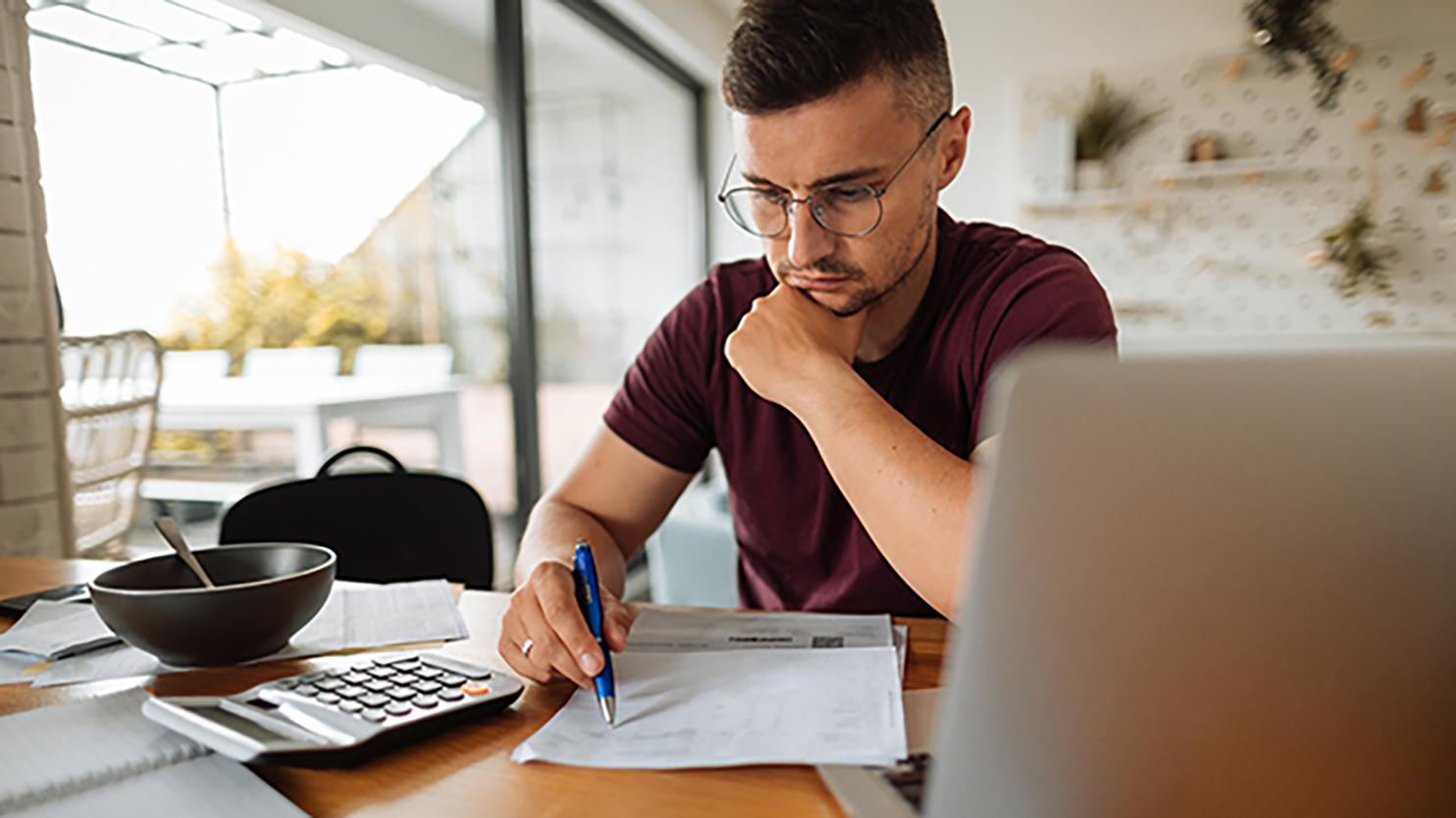 Image of male with calculator and computer