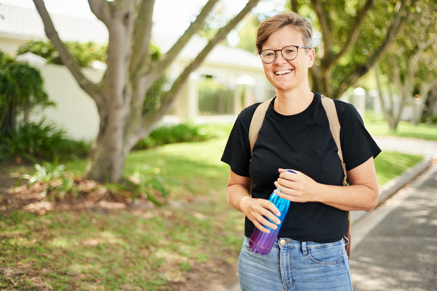 Image of middle aged woman with backpack and water bottle