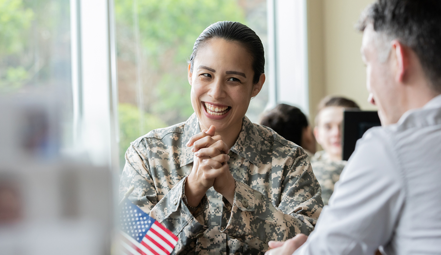 Image of female veteran student talking to faculty member