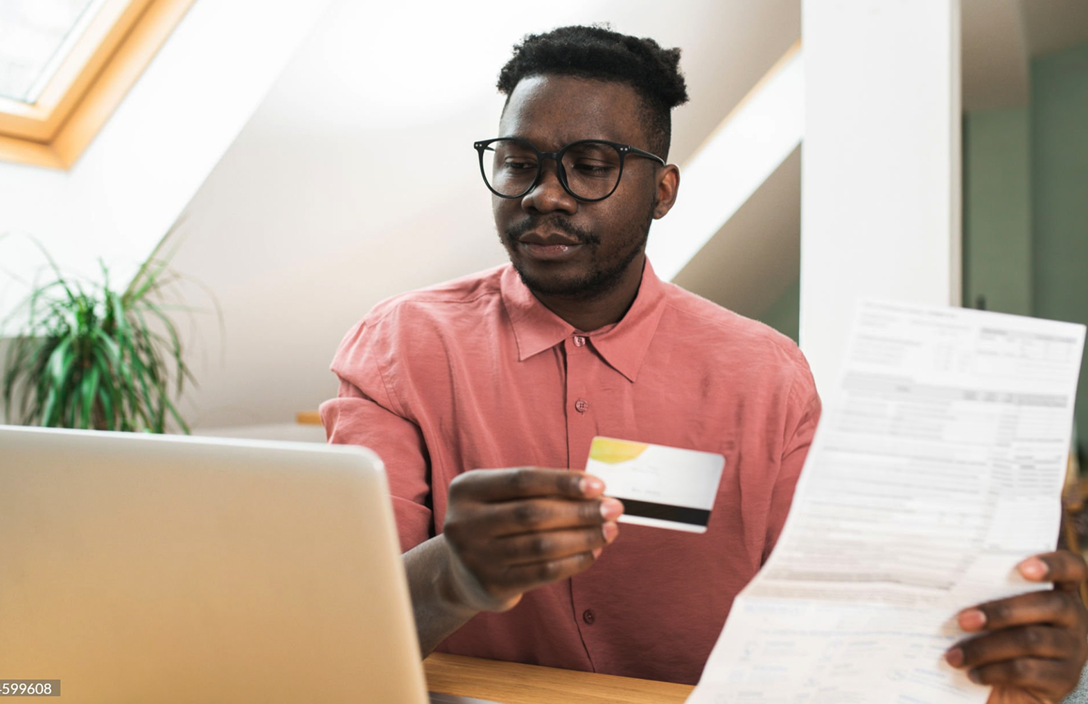 Image of person looking at documents and computer