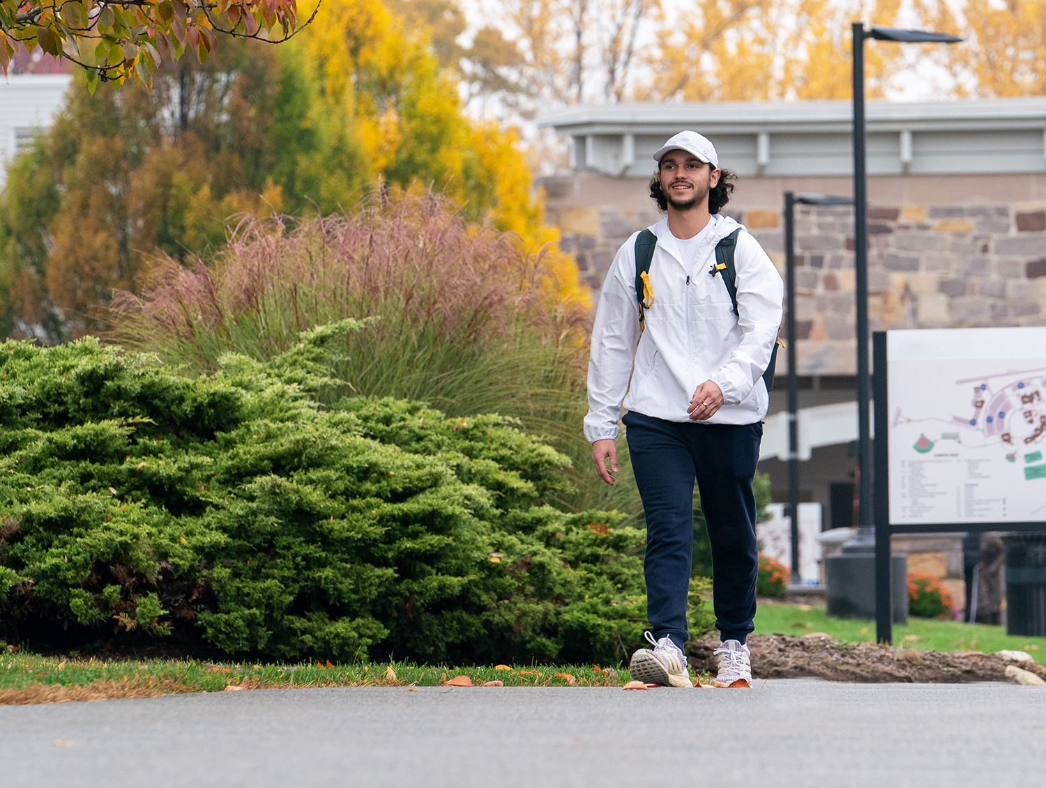 Image of male student walking on campus