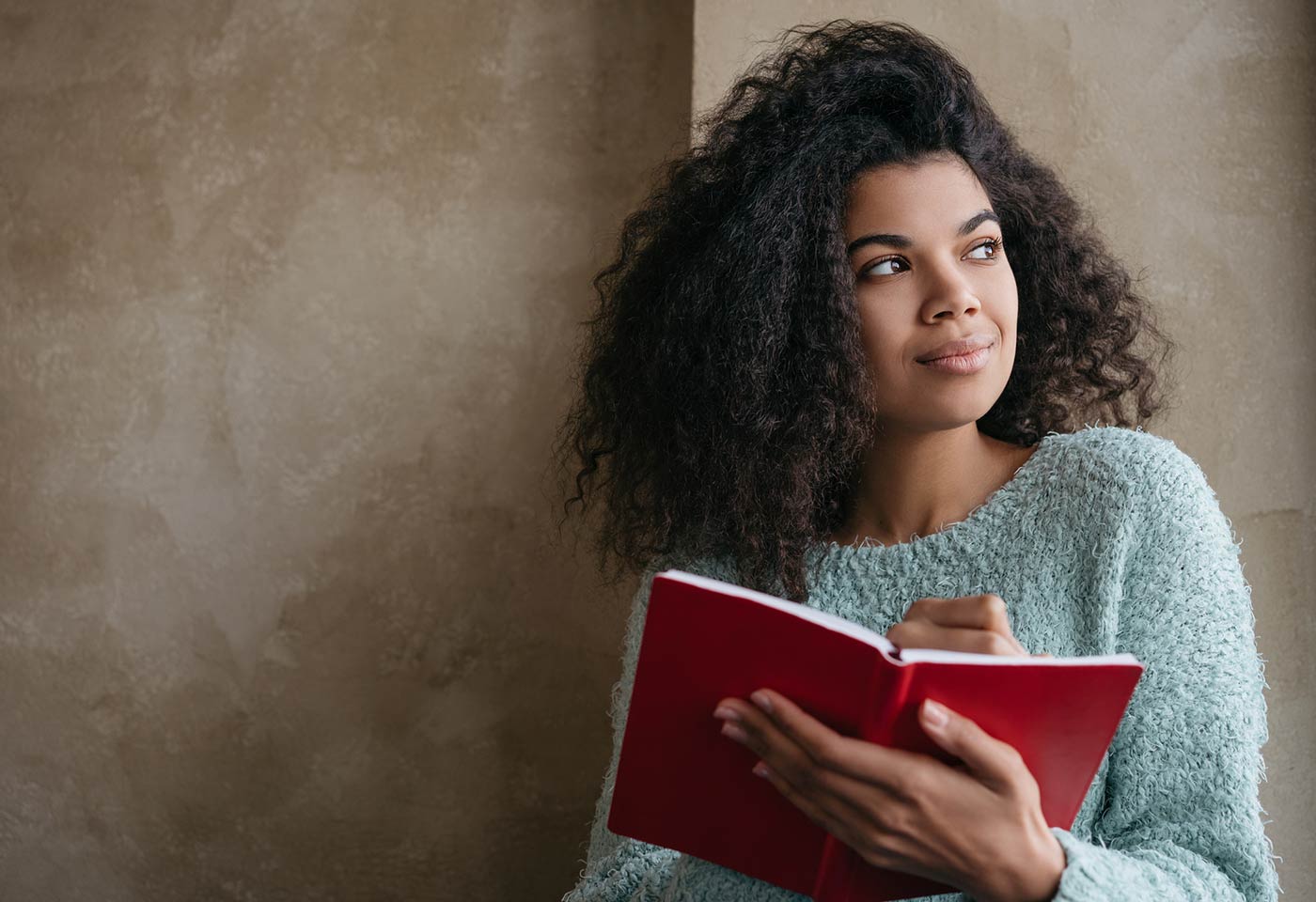 Female student standing by wall