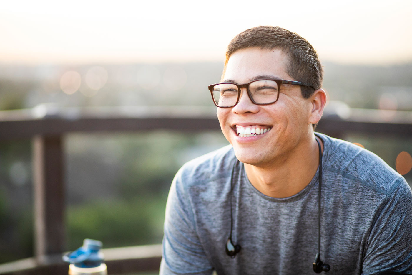 Smiling young man sitting on balcony