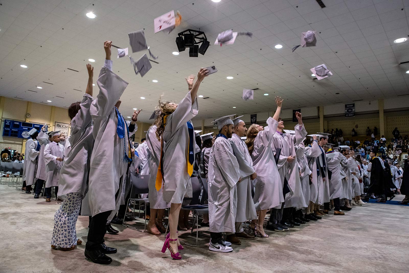 Students throwing caps in the air at graduation